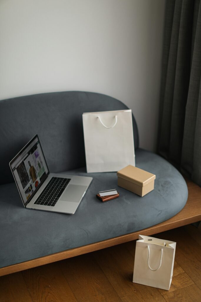 Contemporary e-commerce scene with laptop, shopping bags, and a credit card, ideal for online shopping concepts.